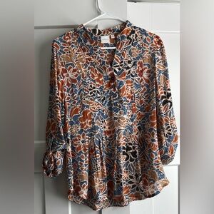 Spring blouse with cuff button sleeves great with light wash denim .
